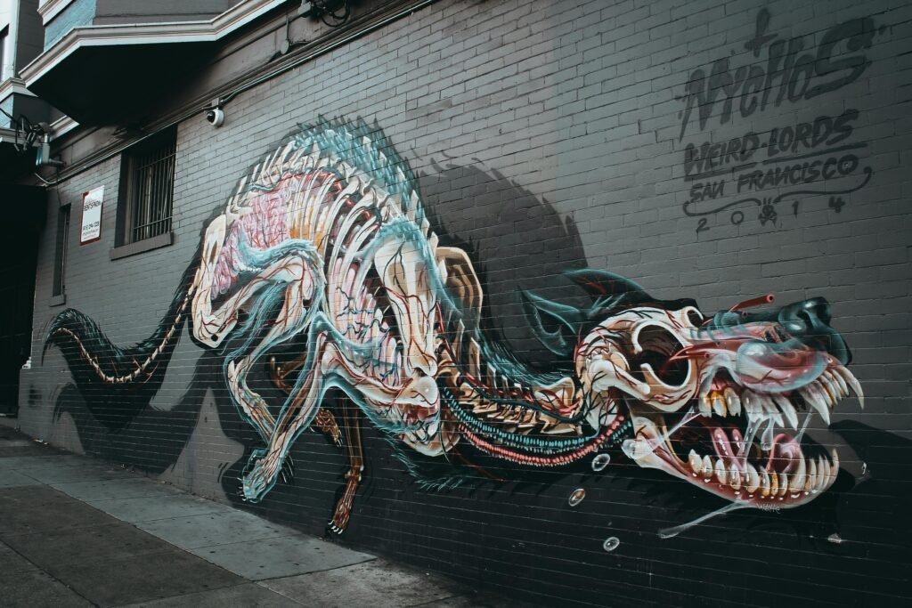 Colorful street art mural depicting a dragon on a San Francisco building exterior.